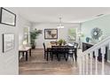 Dining area with natural light, wood floors, and modern decor creating an inviting space at 9128 Stromboli Ct, Kissimmee, FL 34747