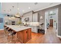 Gourmet kitchen featuring an island with marble countertop, stainless steel appliances, and stylish pendant lighting at 10836 Royal Cypress Way, Orlando, FL 32836