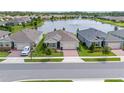 A serene lakefront setting enhances this new home's appeal with well-manicured lawns in a friendly neighborhood at 17795 Blazing Star Cir, Clermont, FL 34714