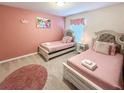 Adorable pink-themed bedroom with two twin beds and princess decor at 1876 Summer Dr, Davenport, FL 33897