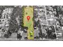 Aerial view of large lot outlined with a red border pinpoints the property location in a neighborhood surrounded by trees at 1886 Pleasant Hill Rd, Kissimmee, FL 34746