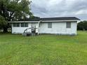 Quaint, single-story home with a traditional design and a spacious, grassy front yard at 1886 Pleasant Hill Rd, Kissimmee, FL 34746