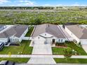 An aerial view of a well maintained home and surrounding area with manicured lawns at 1951 Partin Terrace Rd, Kissimmee, FL 34744