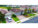 Lovely single-Gathering home featuring a brick driveway, clay tile roof, and green space at 2016 Lakeside Ave, Davenport, FL 33837