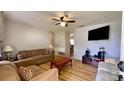 Inviting living room with ceiling fan, hard wood floors, and comfortable seating arrangement at 2127 Patrick St, Kissimmee, FL 34741