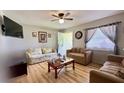 Bright living room featuring hardwood floors, comfortable sofas, and natural light at 2127 Patrick St, Kissimmee, FL 34741