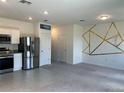 Open concept living room featuring tile and carpet floors, white walls, and modern decor at 254 Mandovi St, Davenport, FL 33837
