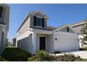 Charming two-story home with a two car garage and a neatly landscaped front yard at 2863 Big Sur Rd, Davenport, FL 33837