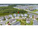 Community aerial view highlighting the home's location near a green space and a lake with many similar homes at 3052 Prelude Ln, Kissimmee, FL 34746
