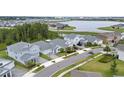 Aerial view of a residential community with a lake view on a sunny day at 3052 Prelude Ln, Kissimmee, FL 34746