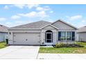 Charming single-story home featuring a two-car garage, well-manicured lawn, and inviting front entrance at 3062 Royal Tern Dr, Winter Haven, FL 33881