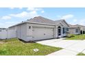 Charming single-story home featuring a two-car garage, well-manicured lawn, and inviting front entrance at 3062 Royal Tern Dr, Winter Haven, FL 33881