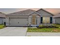 Charming single-story home featuring a two-car garage, well-manicured lawn, and inviting front entrance at 3062 Royal Tern Dr, Winter Haven, FL 33881