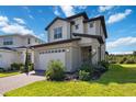 Beautifully landscaped home with a two-car garage and brick-paved driveway at 3224 Oxbow Ct, Harmony, FL 34773