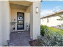 Inviting front porch with decorative wreath and well-maintained landscaping at 3224 Oxbow Ct, Harmony, FL 34773