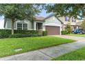 Well-maintained house with a manicured lawn and a brick paved driveway at 3424 Middlebrook Pl, Harmony, FL 34773