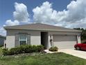 Well maintained home with a neutral color scheme, landscaping and a two-car garage at 3476 Yarian Dr, Haines City, FL 33844