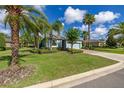 Single-Gathering home with tropical landscaping, a well-maintained lawn, and two-car garage at 3606 Solana Cir, Clermont, FL 34711