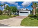 Inviting home with a brick driveway, lush lawn, and a two-car garage at 3606 Solana Cir, Clermont, FL 34711