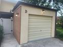 A view of the home's attached garage with updated lighting at 416 Howard Ave # D, Lakeland, FL 33815