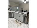 Bright kitchen boasts island sink, stainless dishwasher, and access to outdoor patio through sliding glass doors at 426 Cardinal Ct, Kissimmee, FL 34759