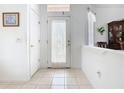 Bright entryway featuring tiled floors, decorative glass door, and fresh white walls perfect for welcoming guests at 572 Sienna Dr, Poinciana, FL 34759