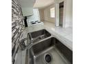 Close up on the kitchen sink with modern faucet and backsplash, and visible appliances at 702 Michigan Ct # 4, St Cloud, FL 34769