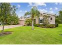 Well-manicured front yard with lush green grass and a mature palm tree in front of the home at 726 Irvine Ranch Rd, Kissimmee, FL 34759
