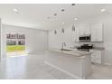 Open kitchen with granite counters, stainless appliances, and a center island at 7554 Sunflower Cir, Kissimmee, FL 34747