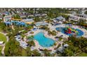 Aerial view of a community waterpark with pools, waterslides, splash pads, and lounge areas at 7616 Brookhurst Ln, Kissimmee, FL 34747
