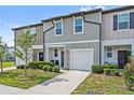 Attractive townhouse with a well kept lawn and garden, attached garage, and neutral palette at 955 Grandin St, Davenport, FL 33837