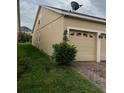 The well-maintained, stucco-sided house has a garage and a meticulously mowed lawn at 9721 Old Patina Way, Orlando, FL 32832