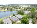 An aerial view of the neighborhood featuring the large lake and mature trees surrounding the area at 9824 Secret Cove Ln, Orlando, FL 32832