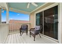 Relaxing balcony space with cozy seating and picturesque views, perfect for enjoying the outdoors at 114 Harwood Cir, Kissimmee, FL 34744