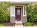 Close-up of front entrance with columns, walkway, lighting and decorative shrubs at 11844 Founders St, Orlando, FL 32832