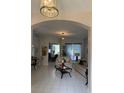 Bright living room featuring tile floors, modern furniture, and an open layout at 216 Boxwood Dr, Davenport, FL 33837