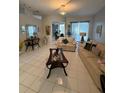 Comfortable living room with tile floors, neutral decor, and a view into the dining room at 216 Boxwood Dr, Davenport, FL 33837