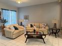 Cozy living room featuring plush seating, decorative pillows, and an inviting atmosphere at 216 Boxwood Dr, Davenport, FL 33837