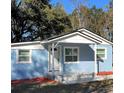 Charming blue exterior with a covered entryway and newly landscaped front yard offers great curb appeal at 217 W Chelsea St, Deland, FL 32720