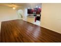 Open-concept living room and kitchen area with hardwood floors and lots of natural light at 2242 Seven Oaks Dr, St Cloud, FL 34772