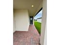 Covered front entrance featuring brick pavers and a stylish front door, offering a welcoming approach at 2505 Merseyside Ct, Haines City, FL 33844