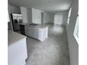Open-concept kitchen featuring a center island, stainless steel appliances, and seamless access to the living area at 2505 Merseyside Ct, Haines City, FL 33844