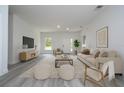 Bright living room boasts neutral tones, modern decor, and plenty of space for relaxation and entertaining at 2580 Gallardia Dr, Lake Wales, FL 33898