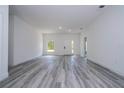 Bright, open living room with light gray flooring and a neutral color palette offers a modern, spacious feel at 2580 Gallardia Dr, Lake Wales, FL 33898
