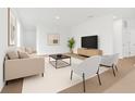 Bright living room boasts modern decor, neutral tones, and ample natural light, creating an inviting atmosphere at 2860 Poppy Avenue, Haines City, FL 33844