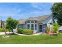 Attractive single-story home featuring a well-manicured lawn and a welcoming entrance with a screened door at 2926 Dickens Cir, Kissimmee, FL 34747