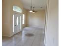 Bright living room featuring tile floors, a stylish decorative inlay, and high ceilings with abundant natural light at 3074 Bay Laurel N Cir, Kissimmee, FL 34744