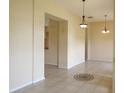 Expansive living area showcasing neutral walls, tile floors, with decorative chandelier lighting at 3074 Bay Laurel N Cir, Kissimmee, FL 34744