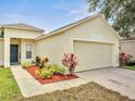Charming home featuring a two-car garage, manicured landscaping, and a well-maintained lawn at 3274 Hunters Chase Loop, Kissimmee, FL 34743