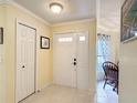 A bright entryway features tile flooring, a closet, and a view into the dining area at 3428 Village Green Ct, St Cloud, FL 34772